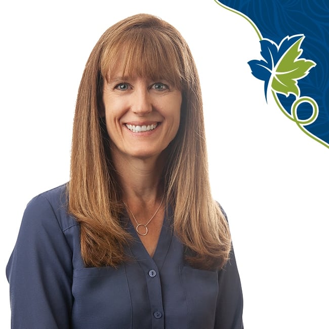 Woman in blue shirt with medium length hair